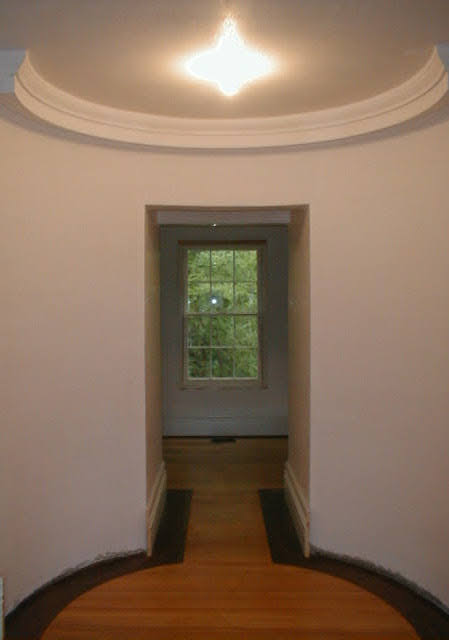 The oval upper hall with domed ceiling and four-pointed star light fixture, completed